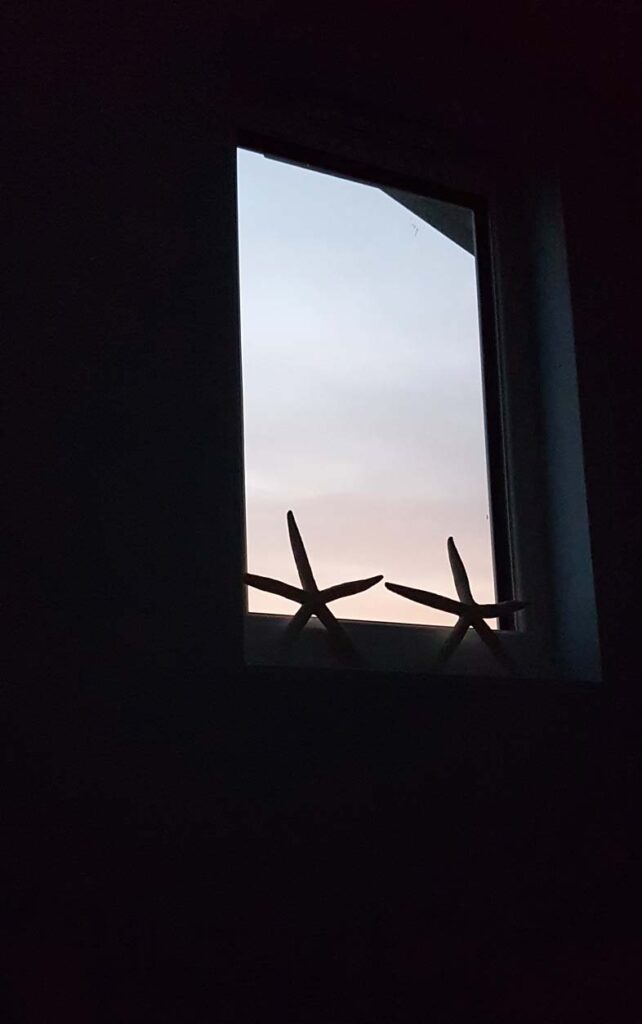 Sunset through an attic window with starfish. Photo taken by Hannah Foley. All rights reserved (hannah-foley.co.uk)